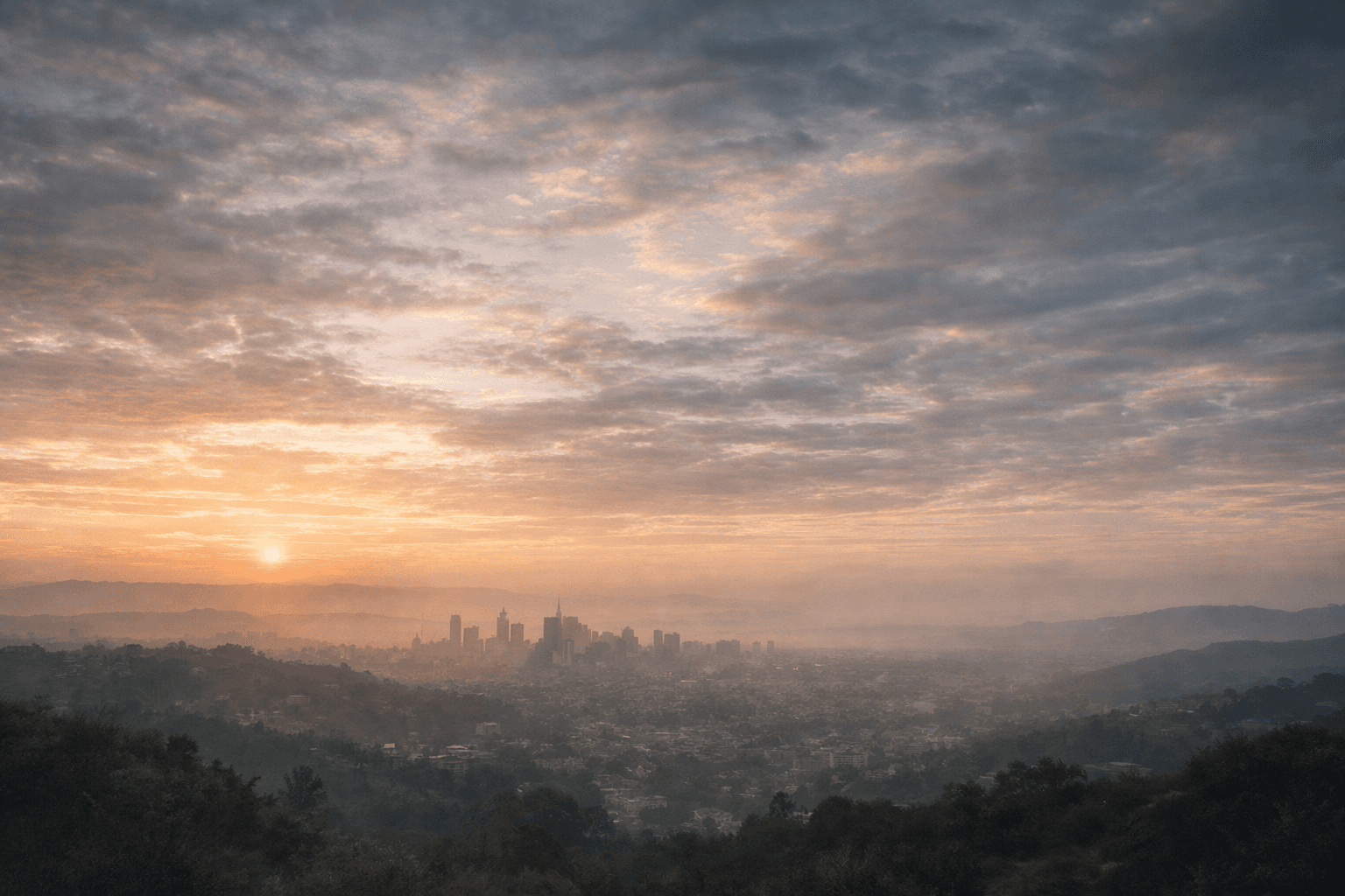 A wide city and sky landscape fading into the page background